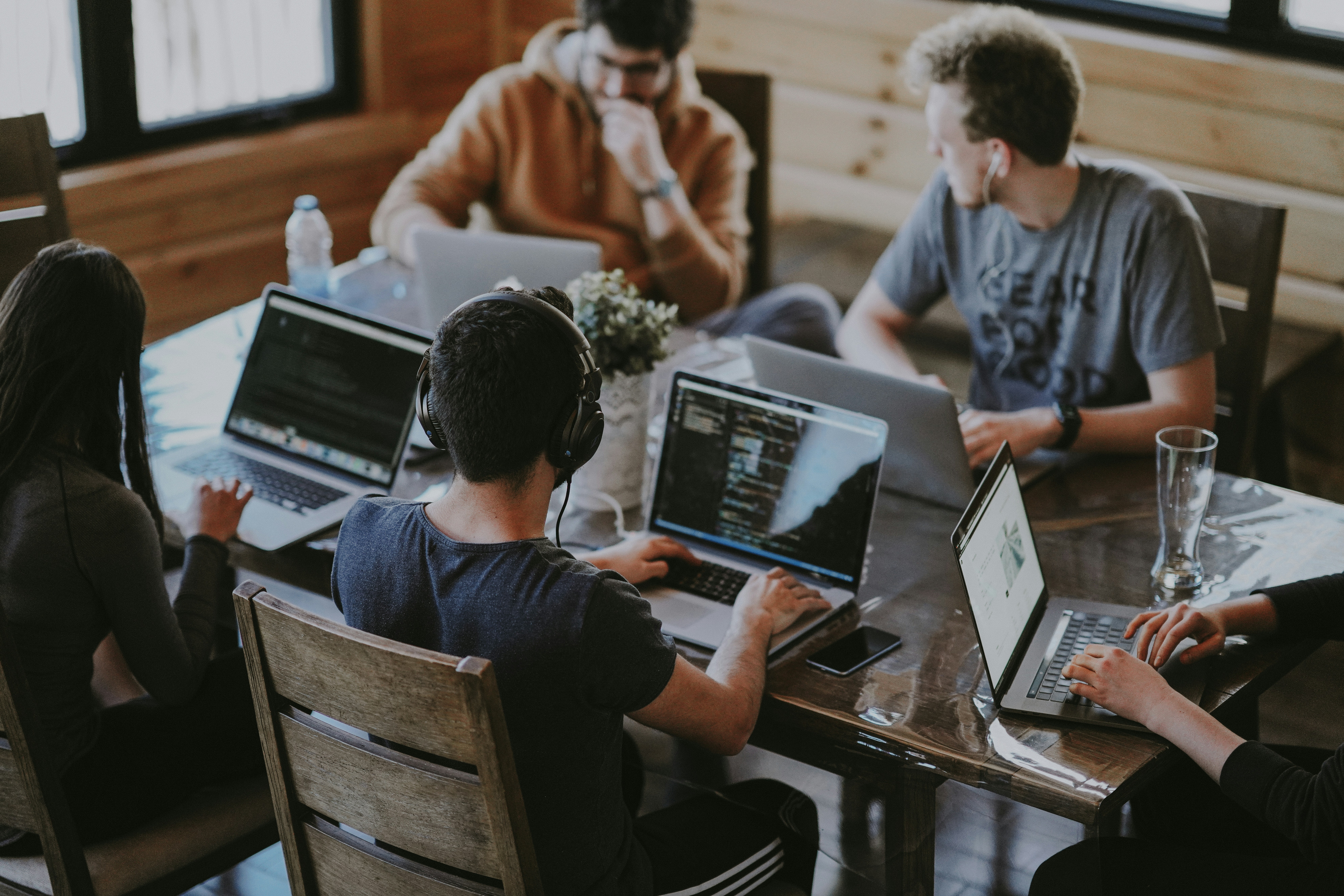 A team gathered around a table with laptops open — a generic collaboration stock photo, not an actual audit checklist infographic