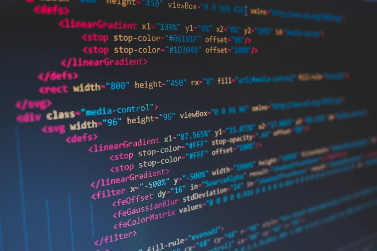 Colorful programming source code filling a dark code-editor screen — generic developer stock photo illustrating the coding-agent comparisons below, not a real screenshot of any tool, editor, or benchmark result