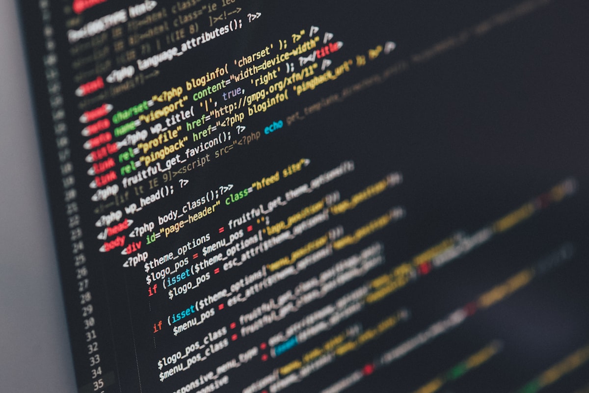 A code editor displaying unrelated PHP source — a generic developer stock photo, not an actual patching priority matrix. See the numbered list above for the real priorities