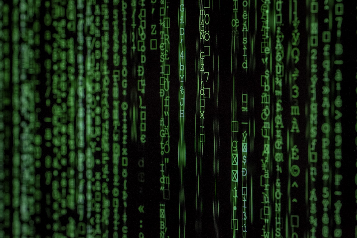 Stylized cascading green code — a generic security stock image, not an actual attack-chain diagram (see the text above for the real attack chain)