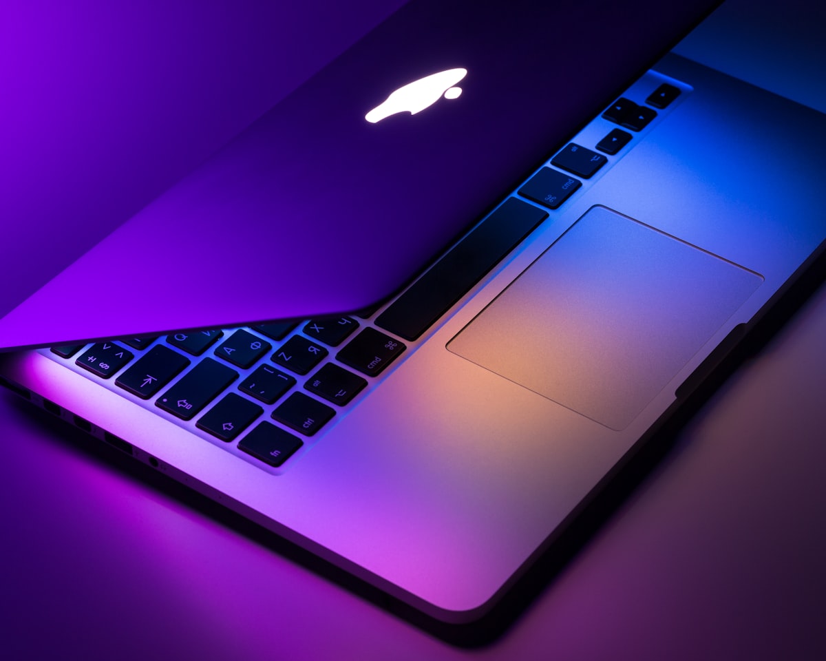 Generic stock photo of a minimal desk with a laptop — illustrative imagery accompanying the discussion of Apple's on-device versus Private Cloud Compute architecture, not an actual architecture diagram