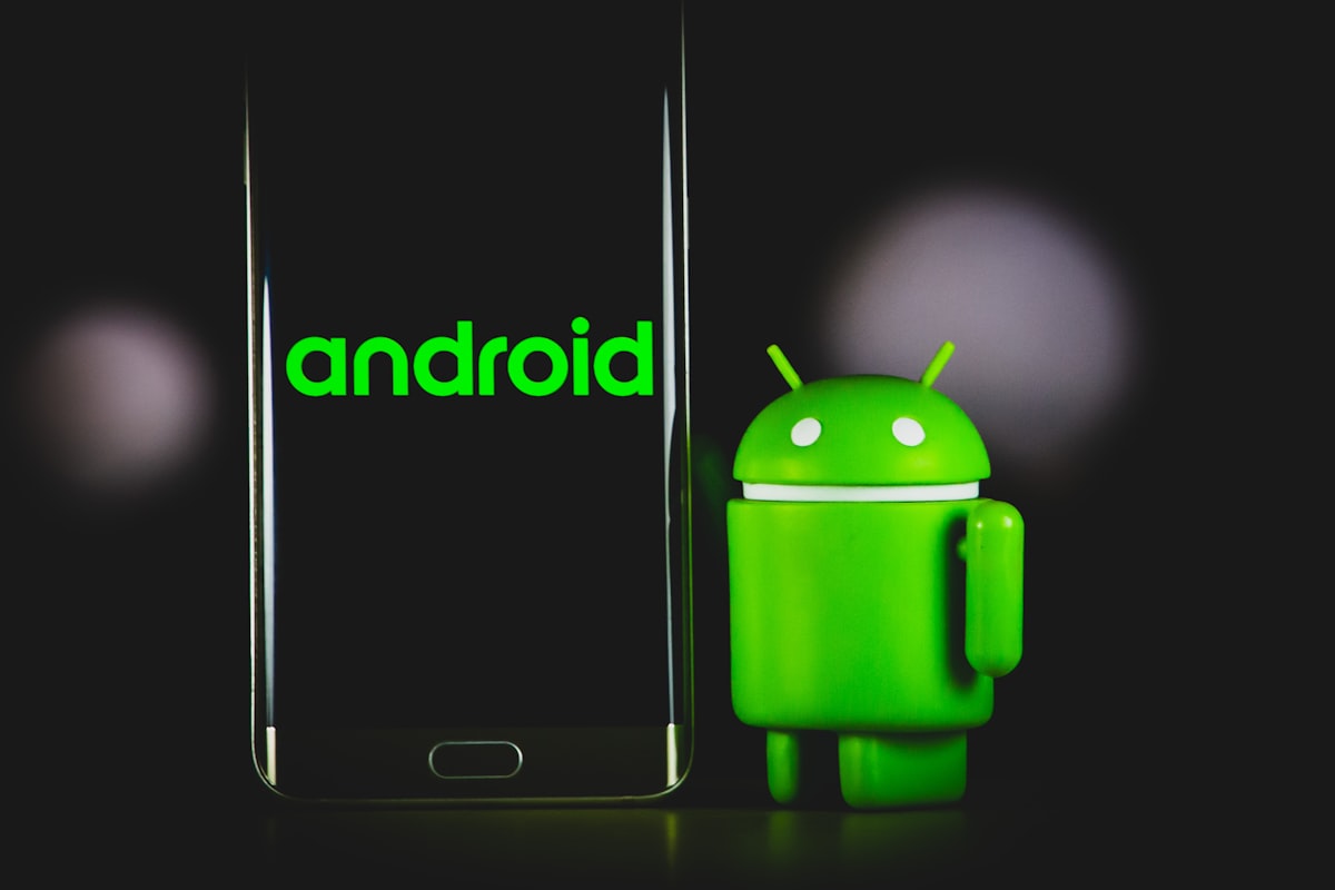 Stock photo of an Android mascot figurine beside an Android smartphone in a dark room, included purely as illustrative tech imagery — it does not depict the Hunyuan Hy4 training pipeline